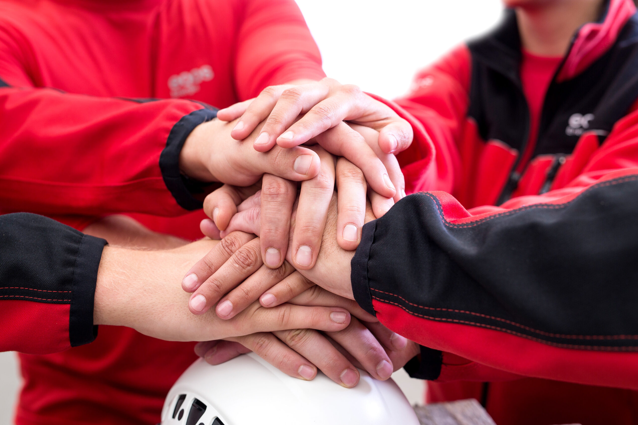 AT-EE170052-Haende-uebereinander-auf-Helm_72dpi-1-scaled-1
